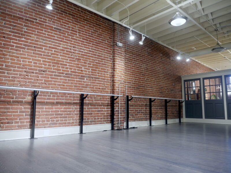 Industry Urban Loft Studios with High Ceilings, Skylights, Grey Hardwood Floors