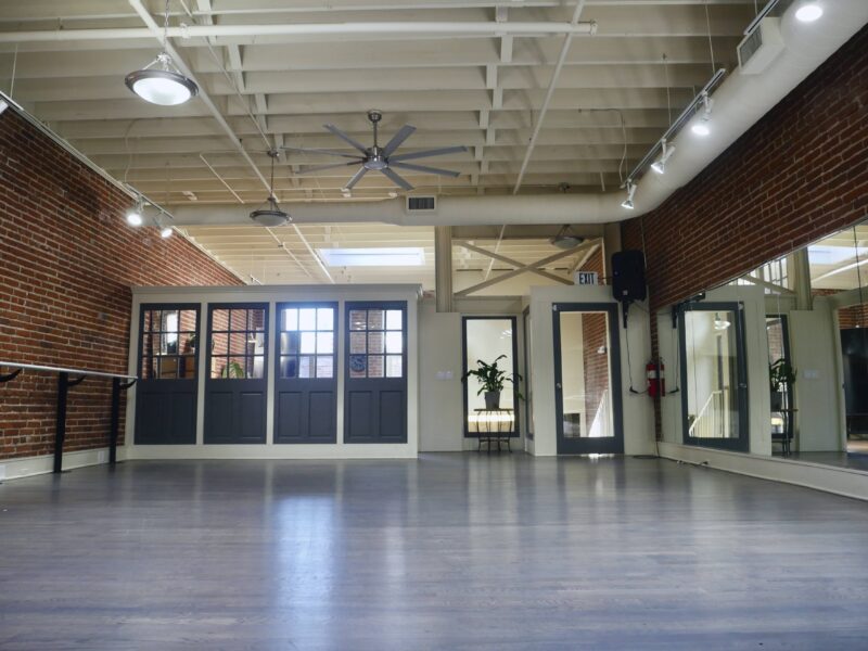 Industry Urban Loft Studios with High Ceilings, Skylights, Grey Hardwood Floors